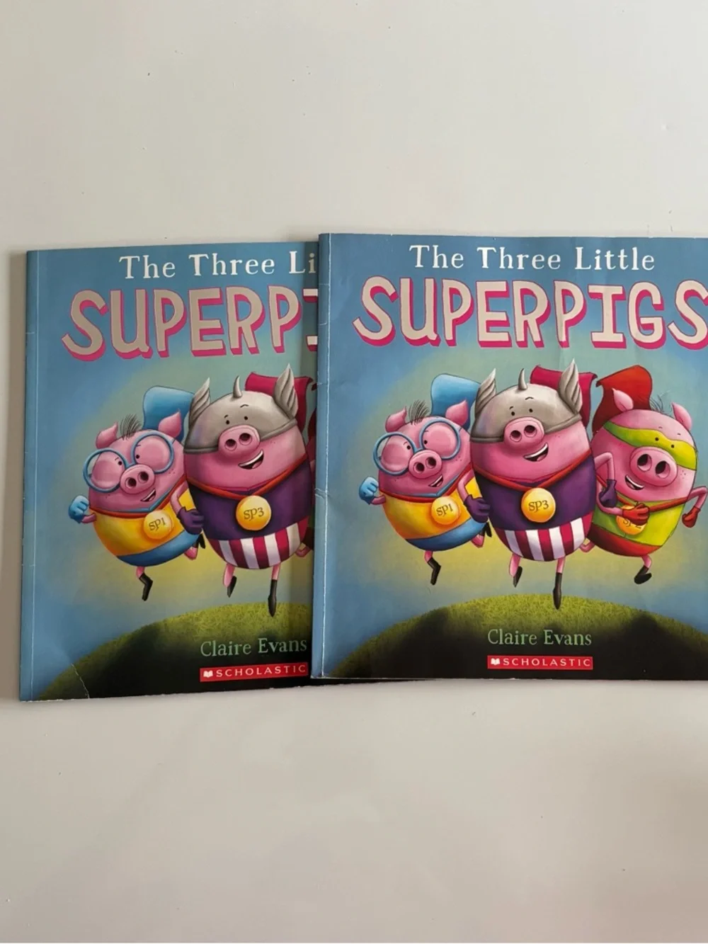 The Three Little Superpigs Children’s Book by Scholastic - two copies